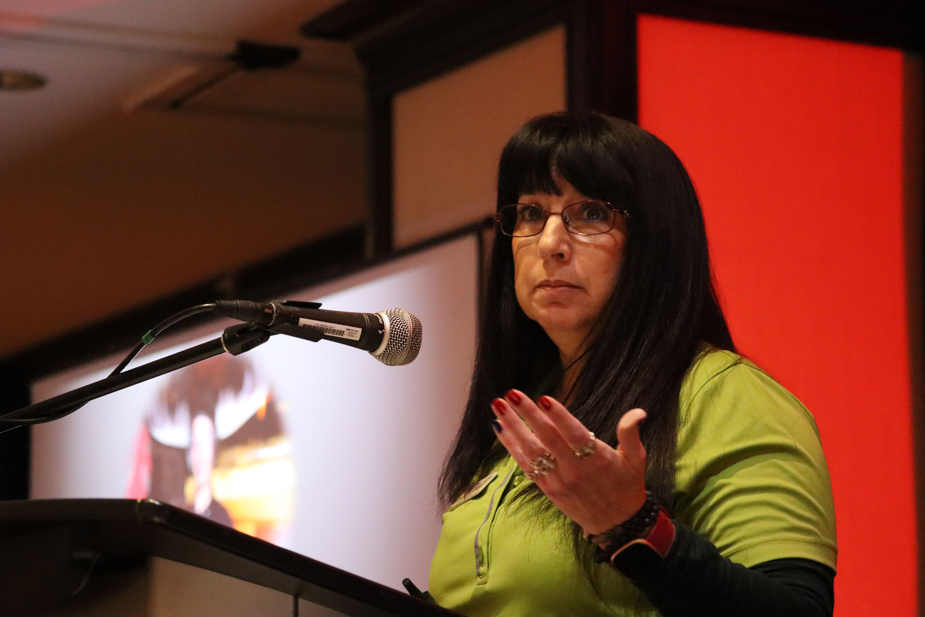 A women speaks at a podium
