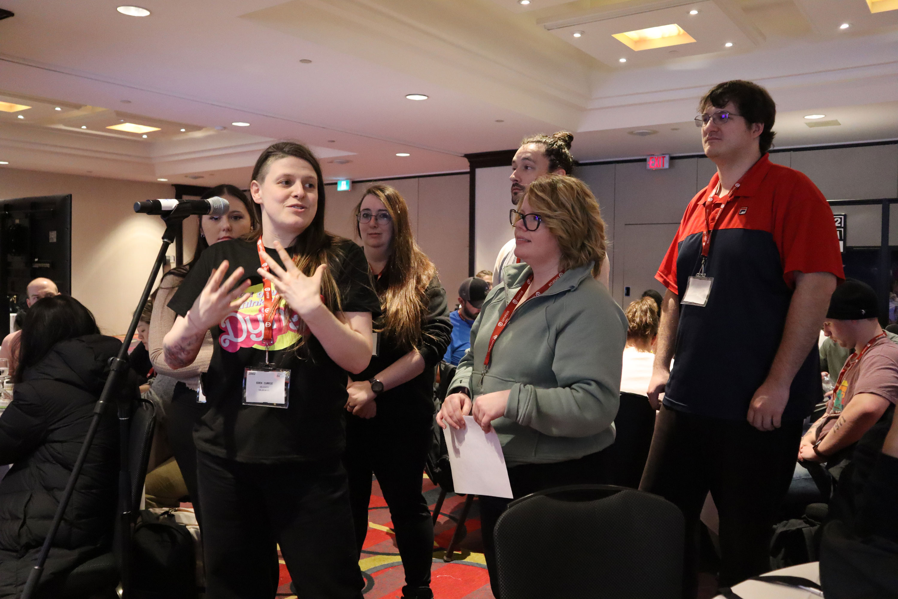 Three people at a mic