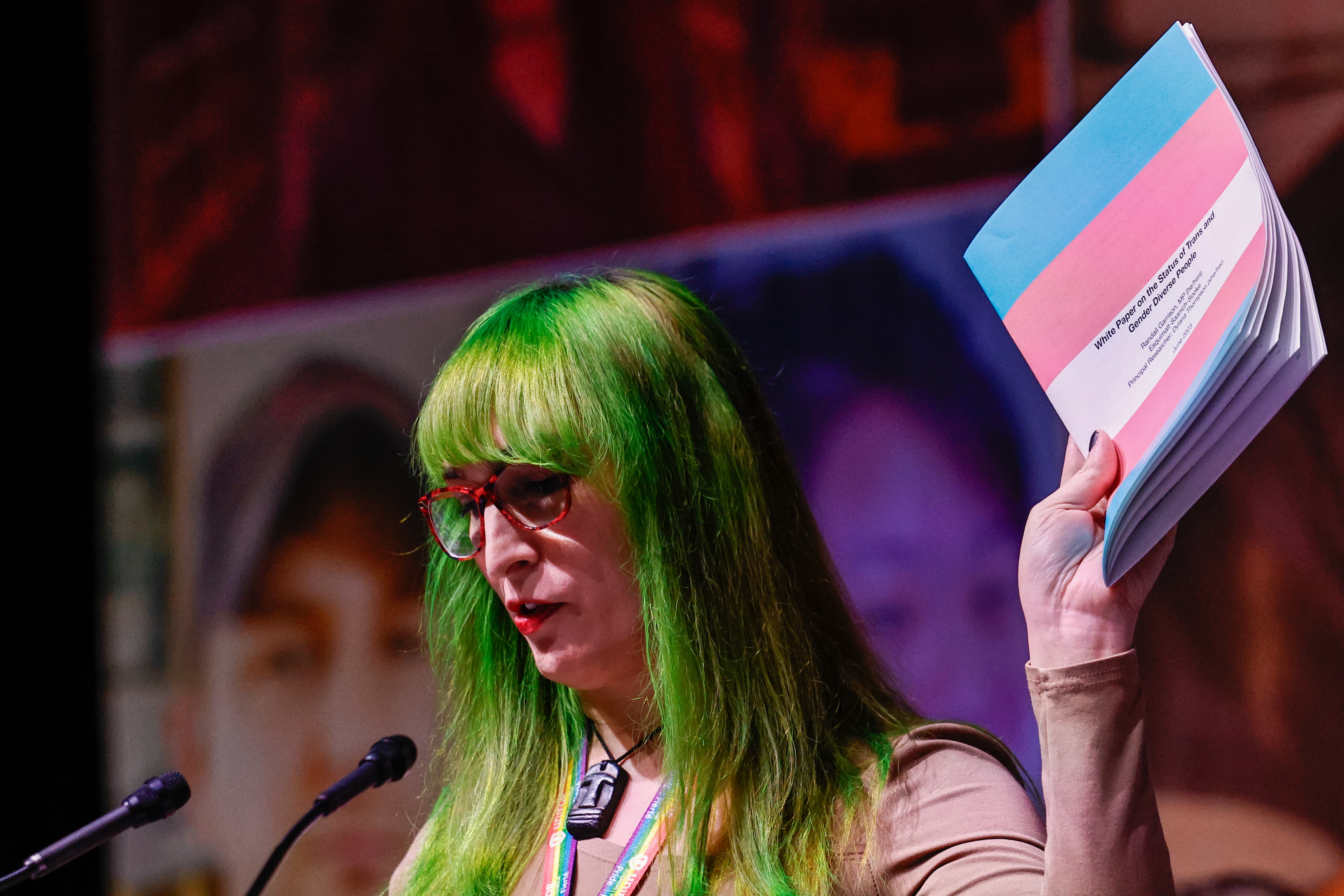 a woman holding up a booklet