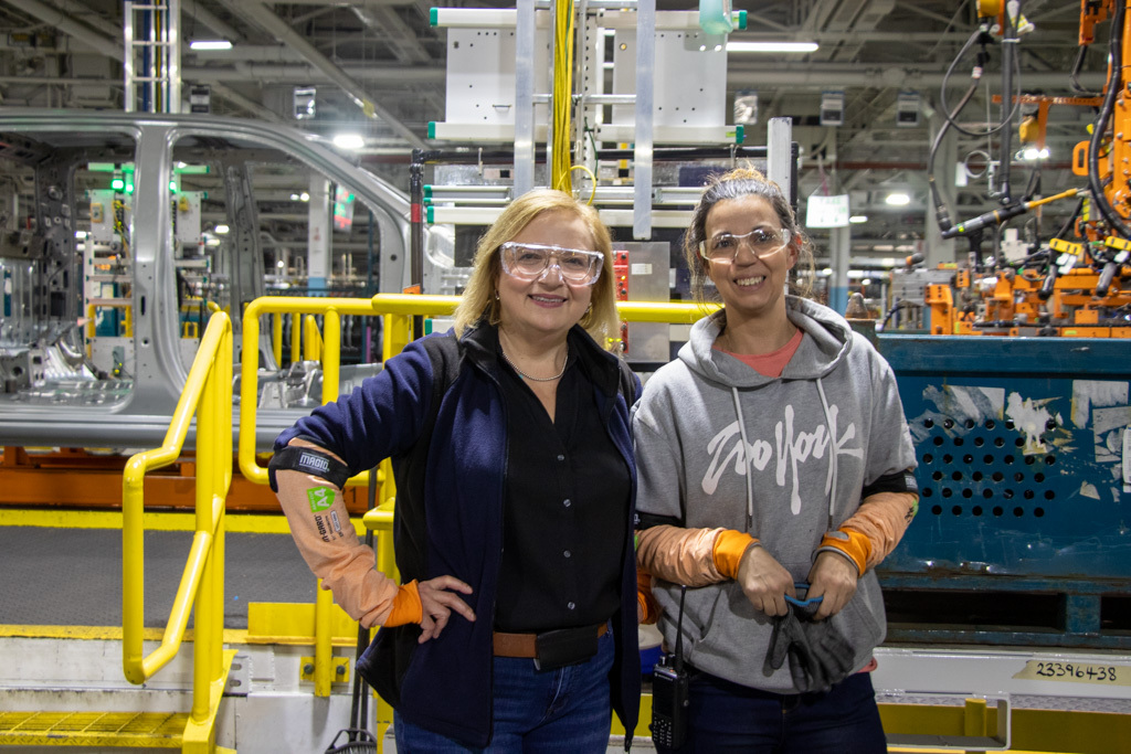 Unifor National President Lana Payne and a Unifor Local 222 member stand on the assembly line at the General Motors Oshawa plant.