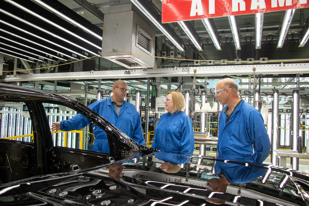 Unifor Local 222 GM Oshawa Plant Chair Jason Gale, Unifor National President Lana Payne, and National Secretary-Treasurer Len Poirier stand on the assembly line at the General Motors Oshawa plant.