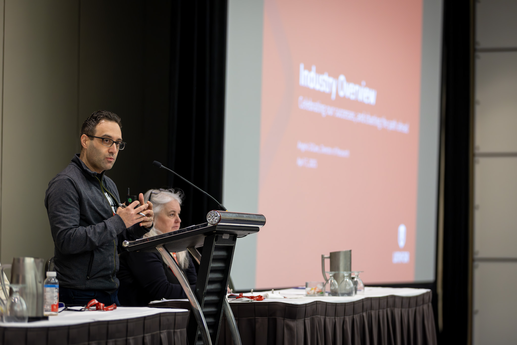 A man presenting at the podium