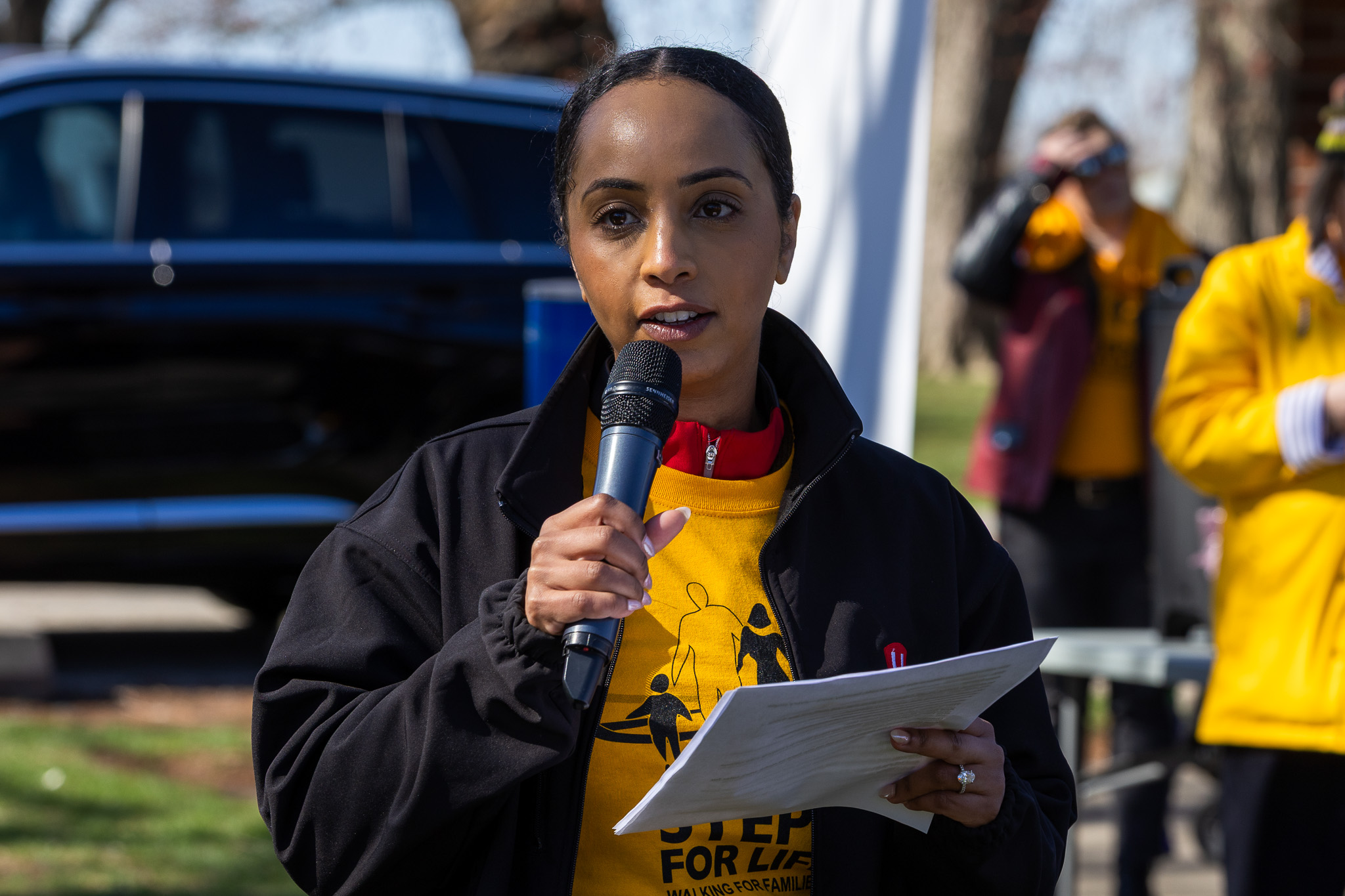 A women speaks into a mic