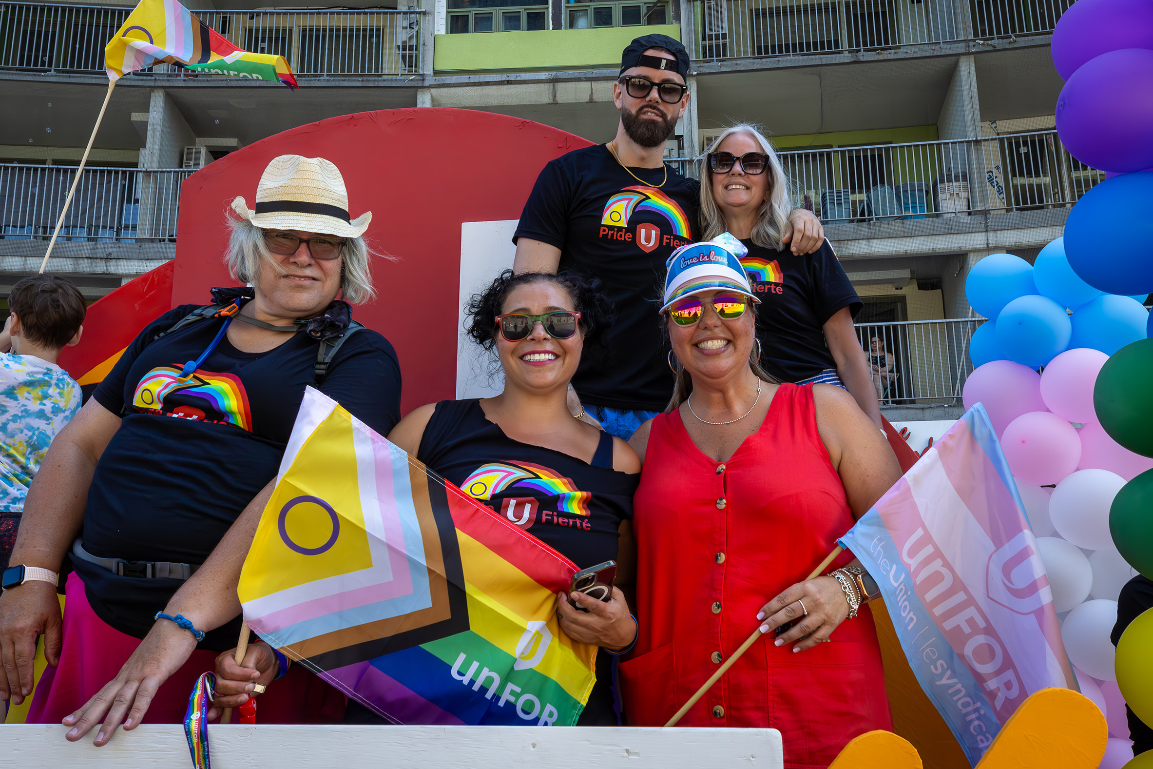 five people smiling on the Unifor Pride float