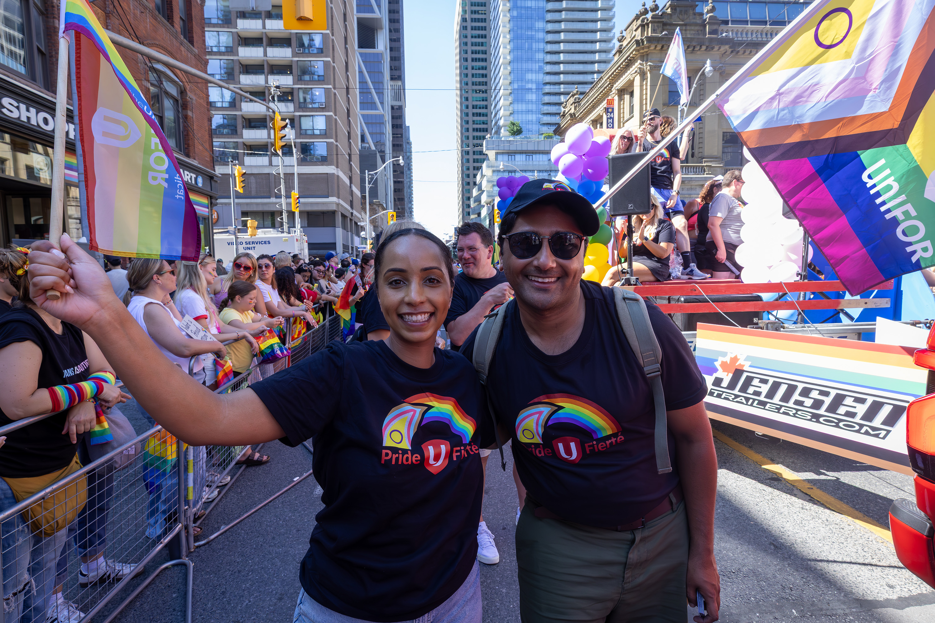 Two people in a parade smiling