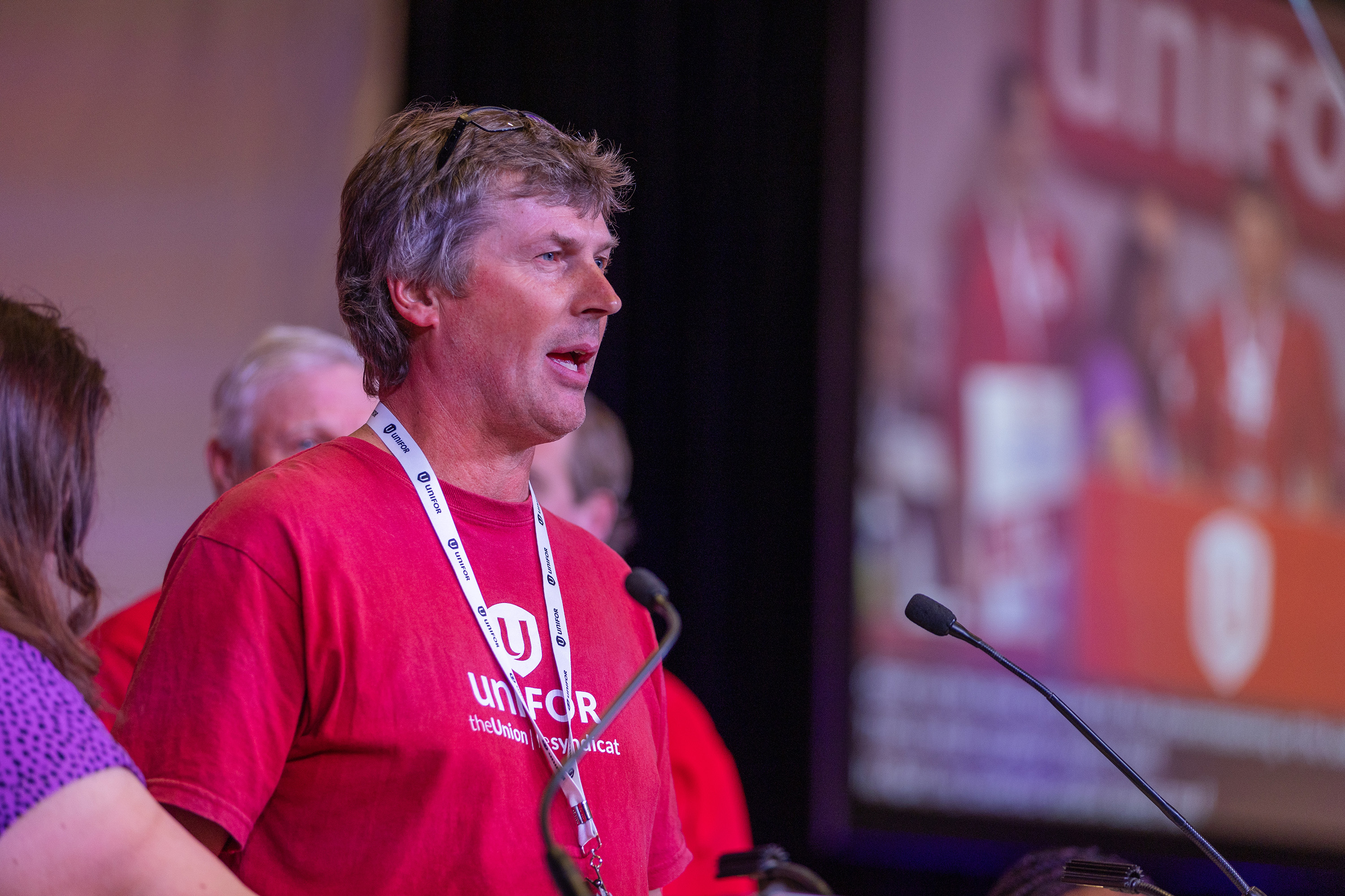 A man speaks at a mic