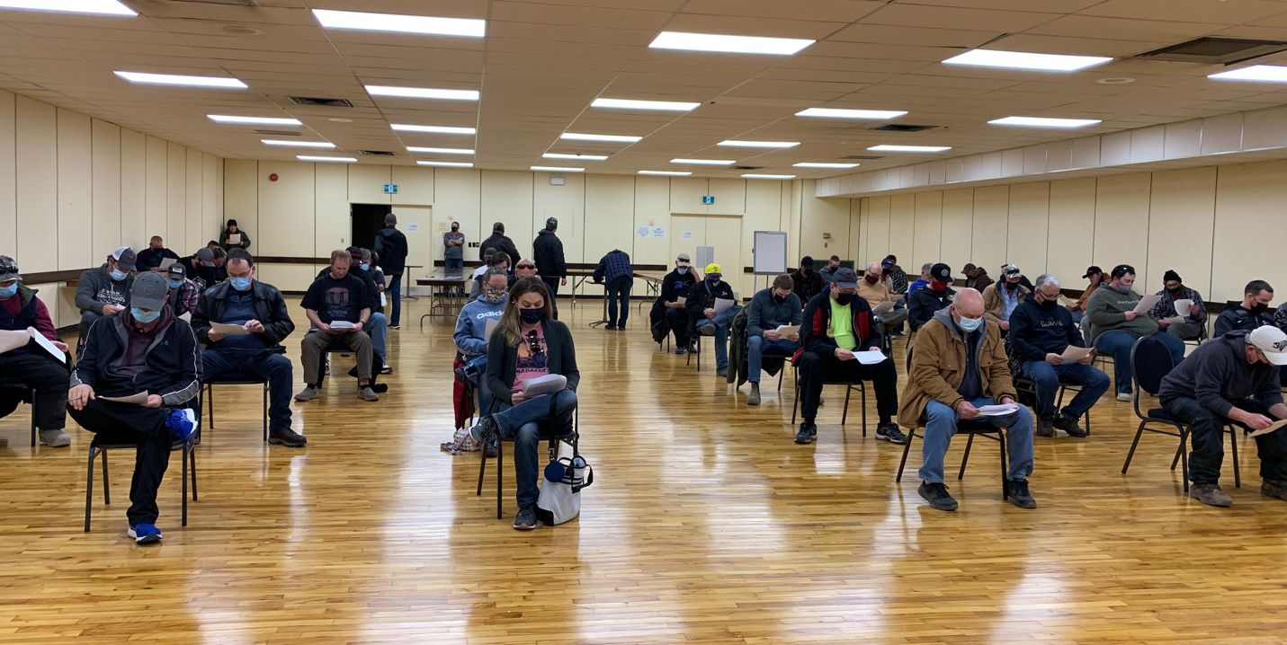 70 Unifor Local 914 members sit six feet apart in gymnasium at ratification meeting 