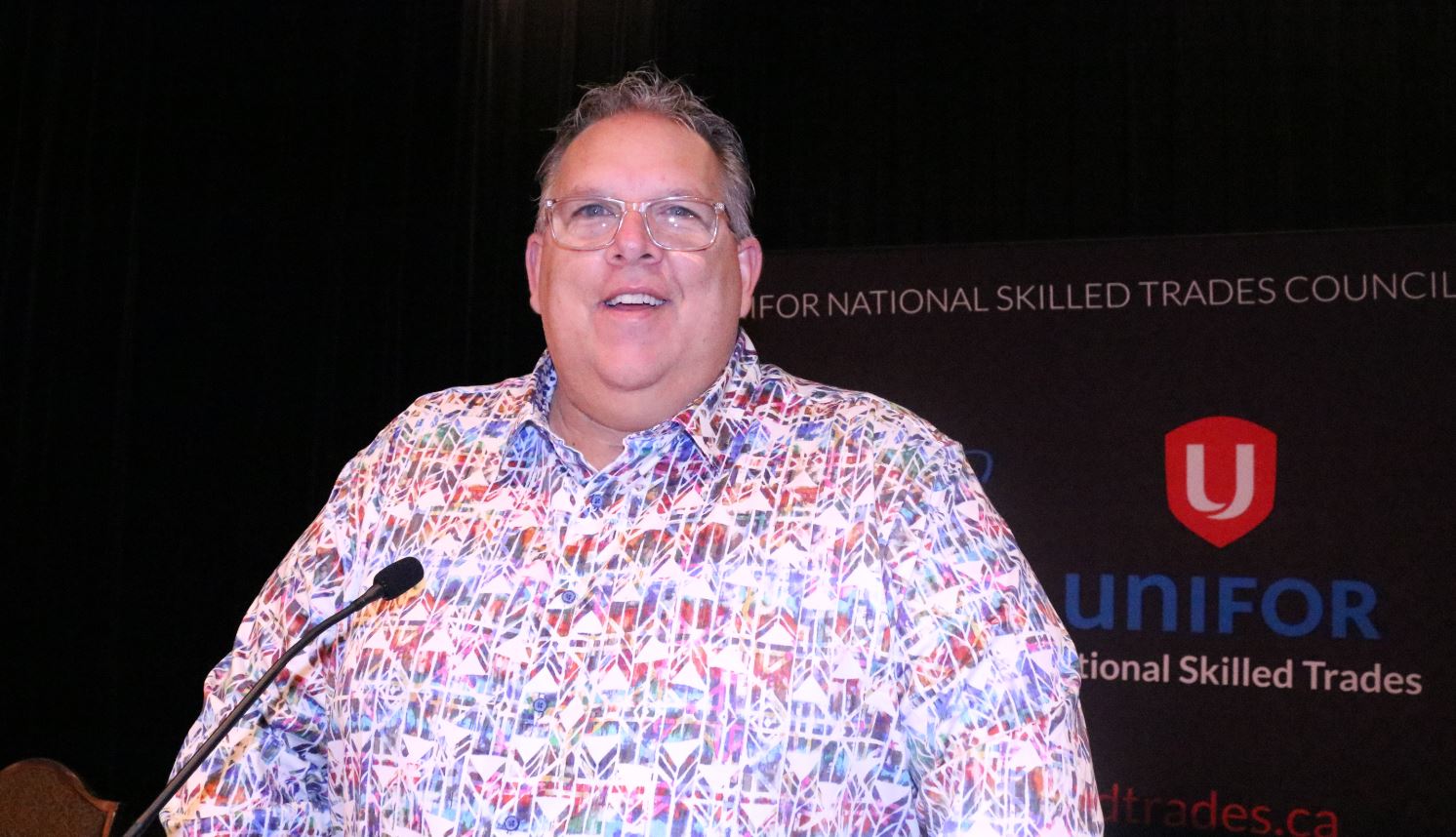 Man standing at podium with microphone