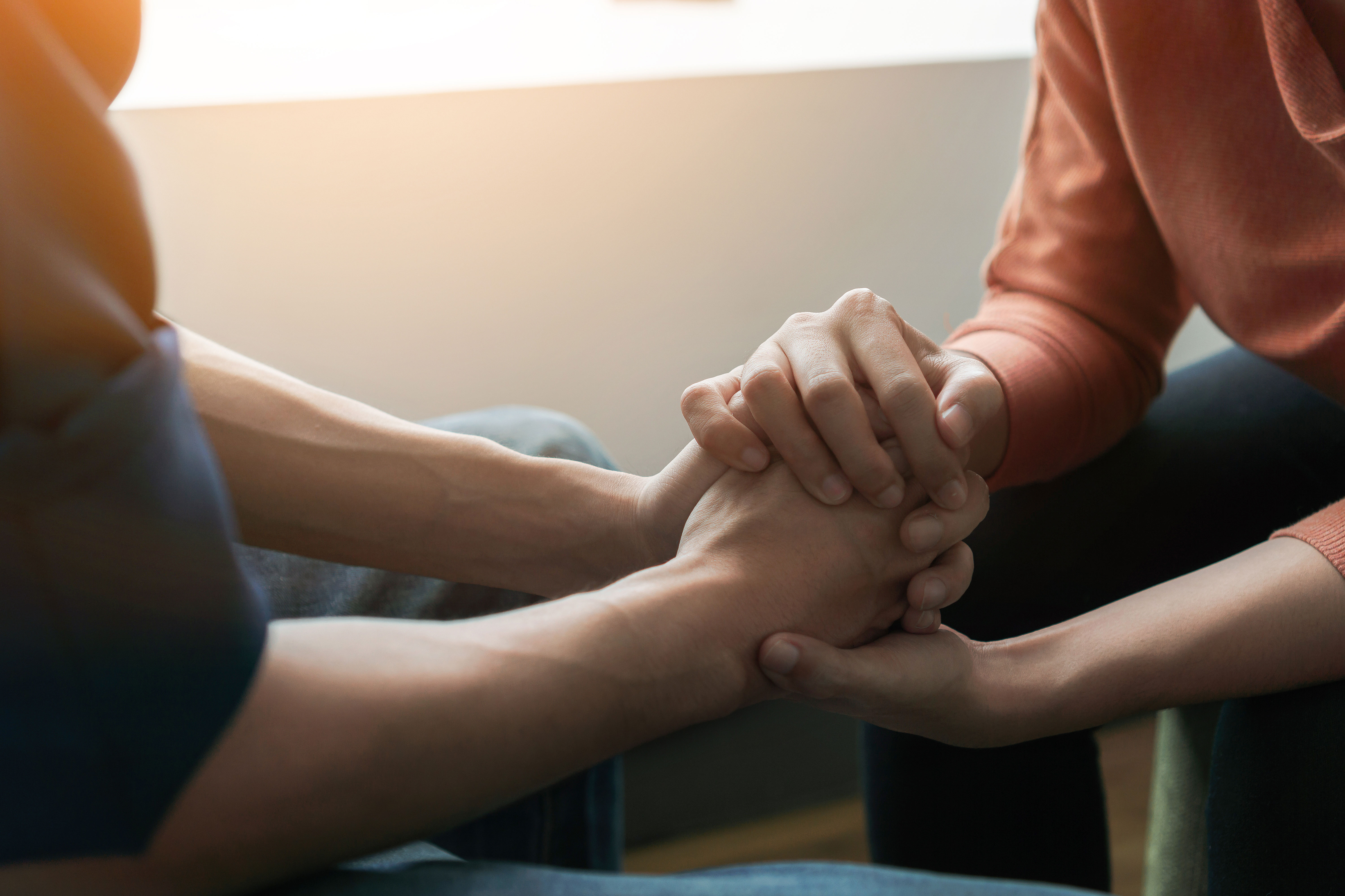 Two people holding hands