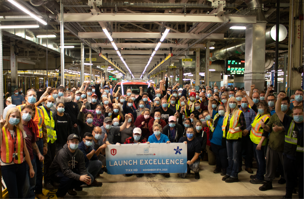 Unifor National President Jerry Dias joins pictured with hundreds of General Motors Oshawa workers in front of the first truck to roll off the assembly line. 