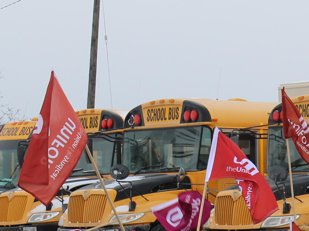 School bus and Unifor flags