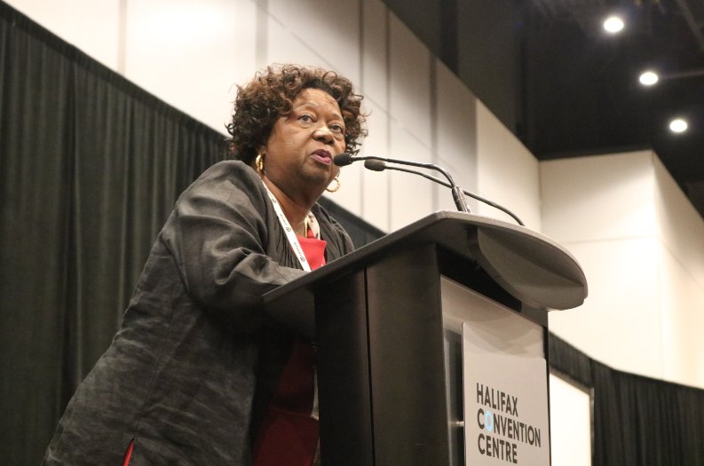 Unifor Nelson Mandela award winner Jean Augustine speaks from a podium at Halifax Convention Centre..