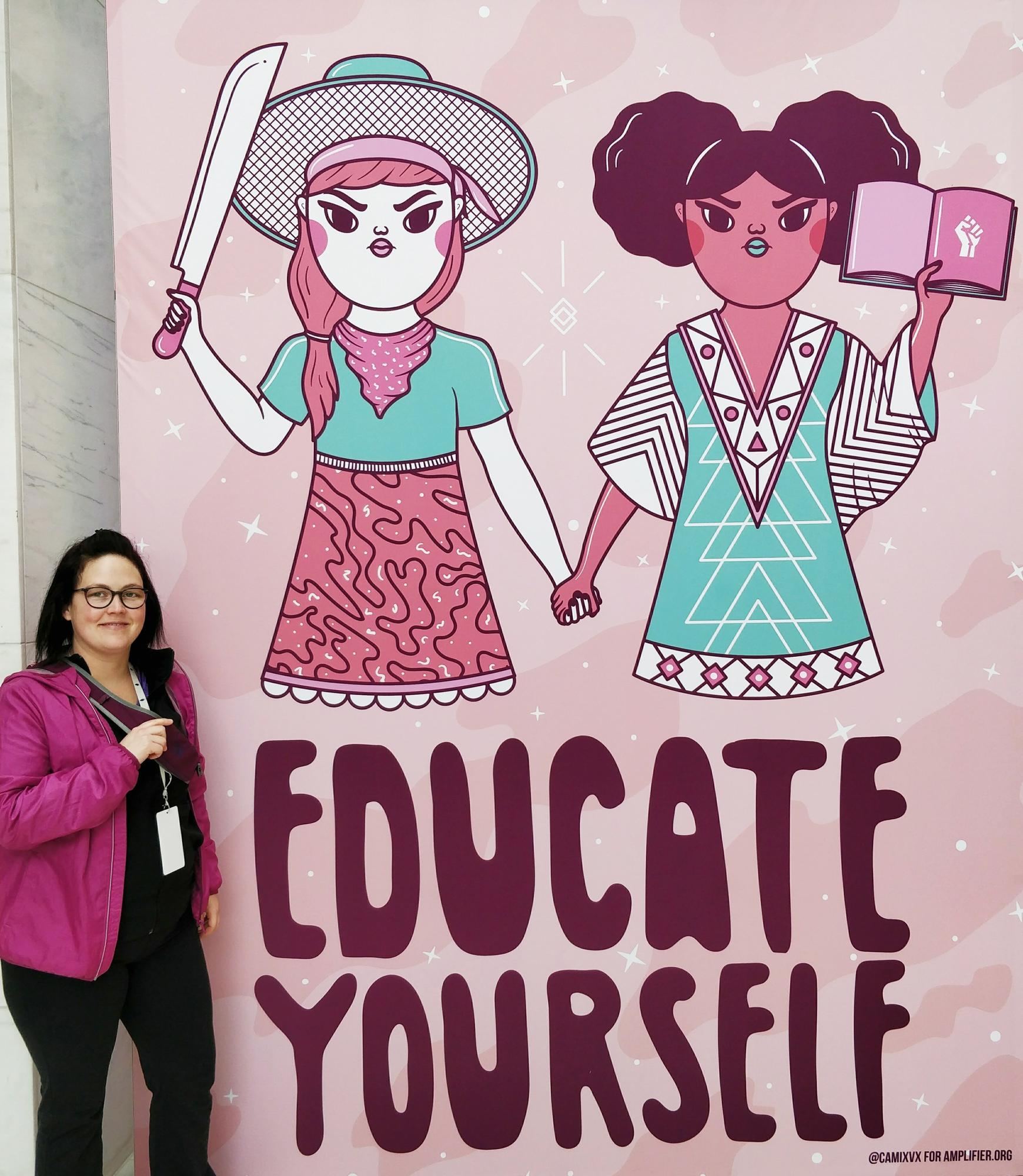 Catherine Plamondon of Unifor Local 720 poses in front of a large mural.