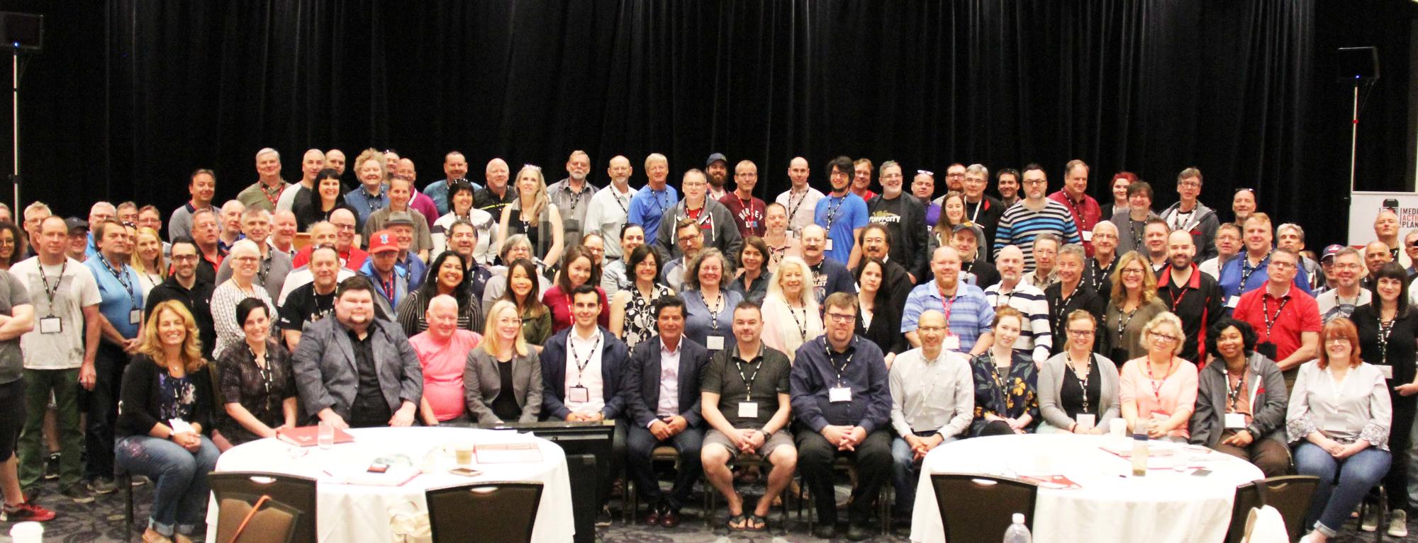 Jerry Dias seated with a large group of delegates to the Unifor Media Council.