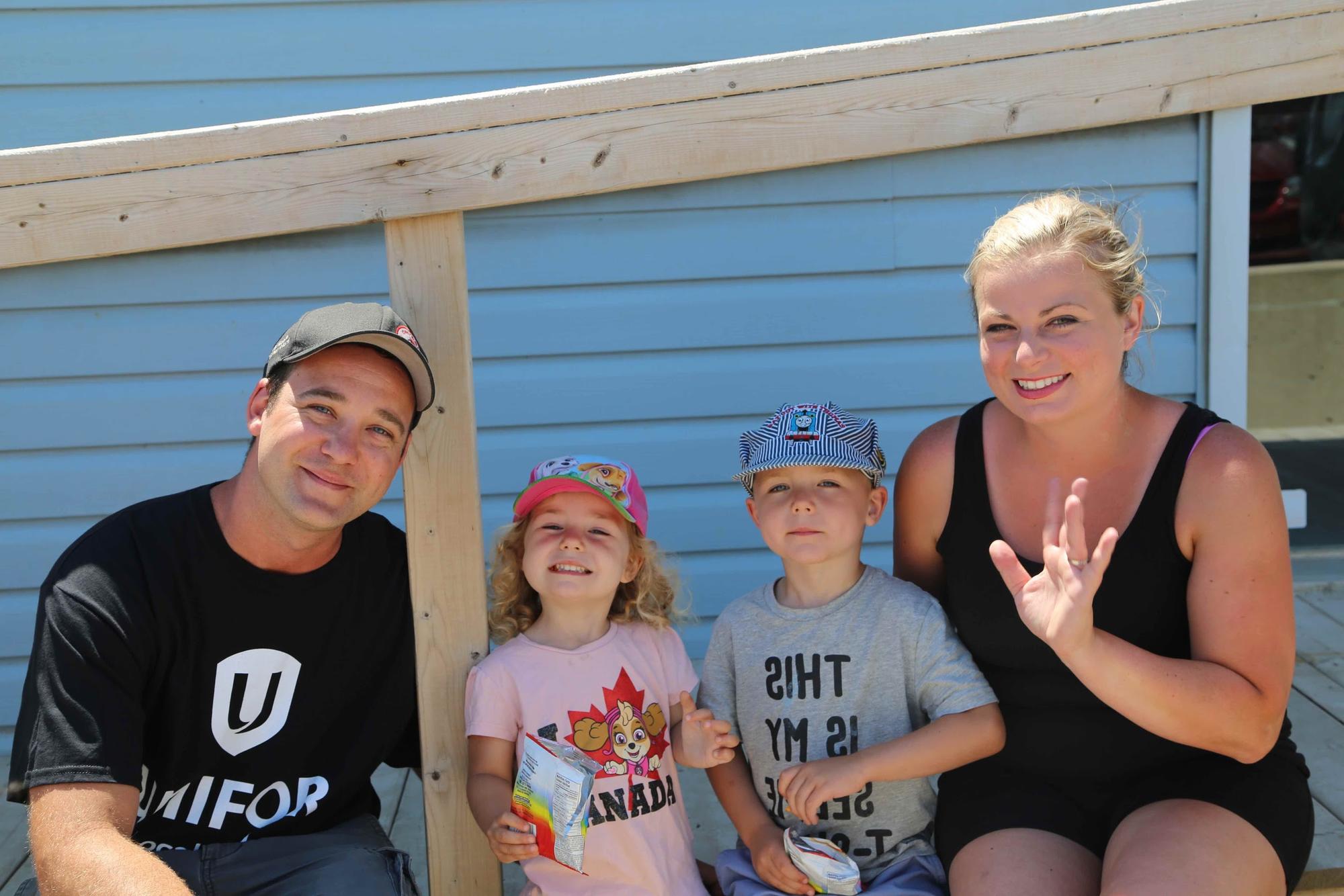 A member of Local 16-O with their spouse and two young children.