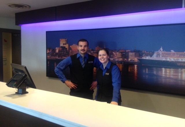 Two Unifor members working at the check-in desk of Saint John Hilton.