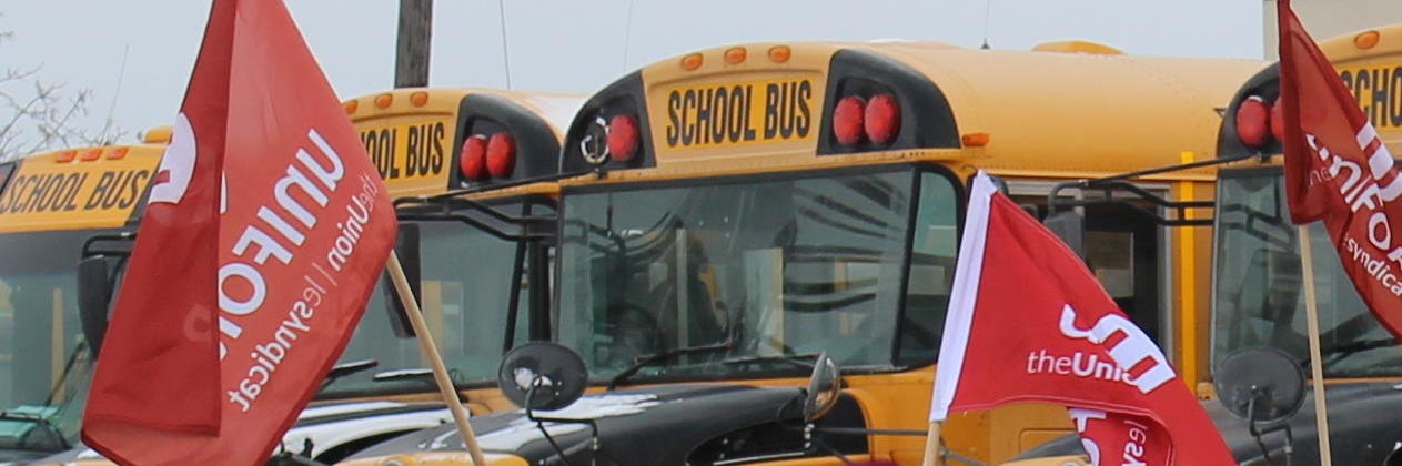 School buses and Unifor flags