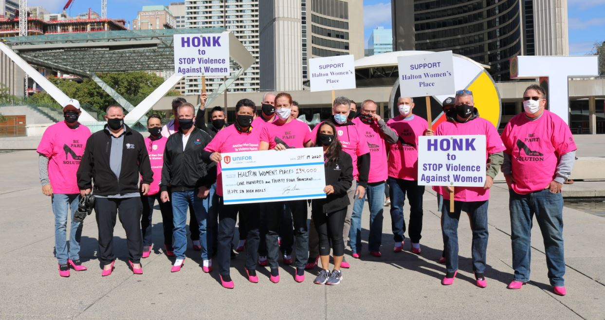 Jerry Dias and a group of activists present a cheque to Halton Women's Place.