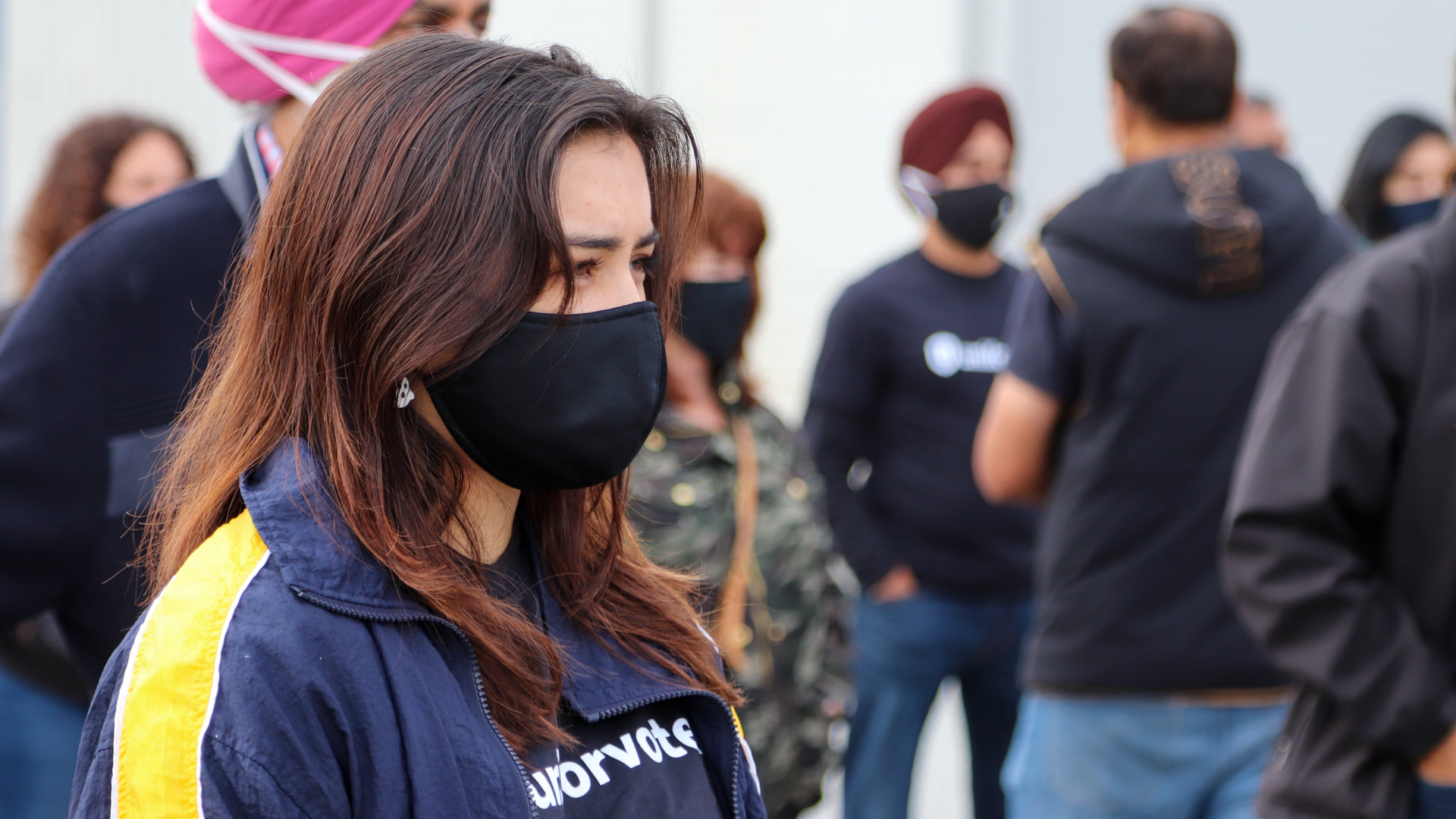 A Unifor member in a mask, and a “Unifor Votes” t-shirt at a recent provincial election event.