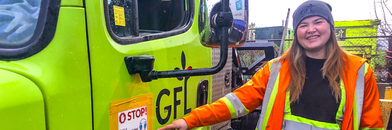 A member of Local 4268 wears brightly coloured safety clothing while standing next to a work vehicle.