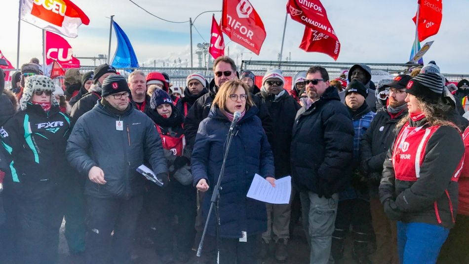 Unifor National President Lana Payne speaking at a microphone the Co-op Refinery gates at a winter 2020 rally