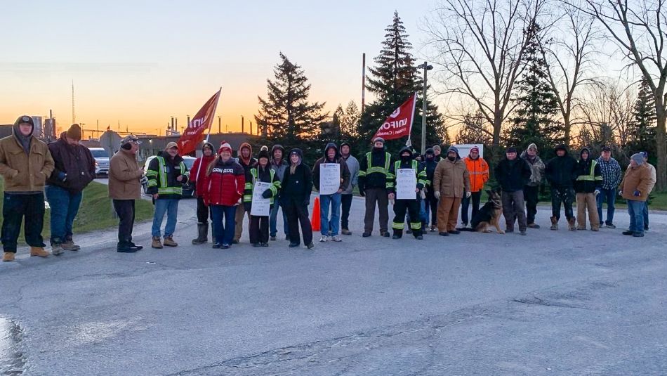 People lined up at a picket line at dawn.