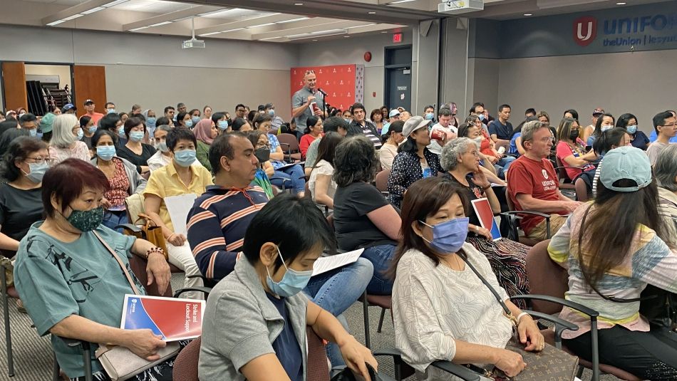 Unifor Local 2000 membership meeting (Purdy's) Room full of Unifor members seated classroom style. On member is standing speaking into microphone at far side of the room.