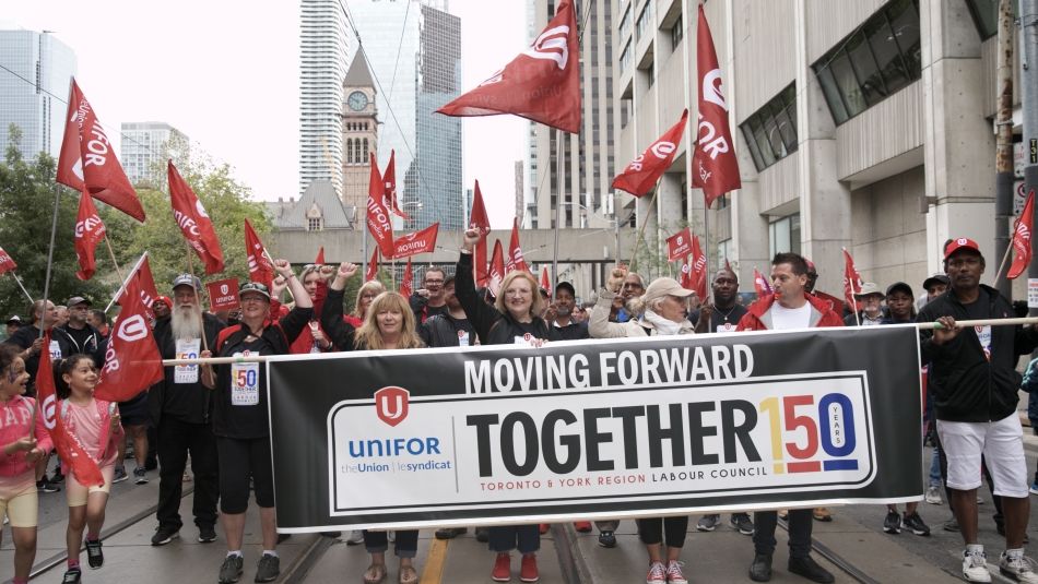 Unifor Mational President Lana Payne marching in the Toronto Labour Day parade with hundreds of Unifor members