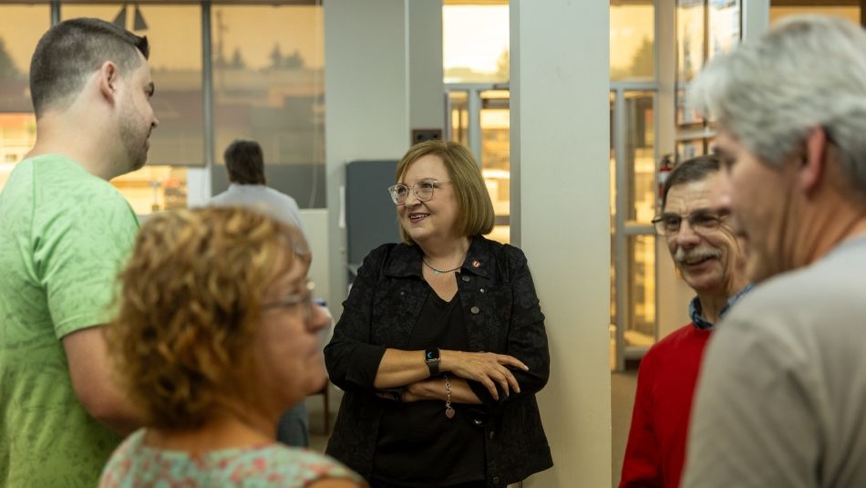 •	National President Lana Payne has conversation with group of members at local meet-and-greet.
