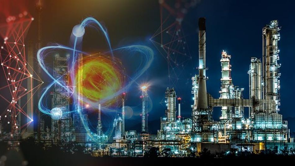 merged image of an illustrated atom and a refinery at night.