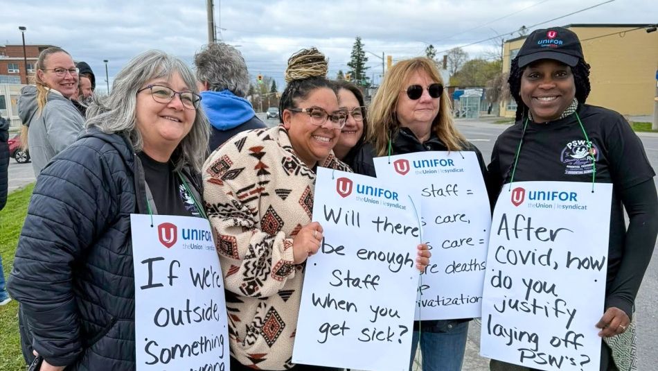 Four people wearing placards 