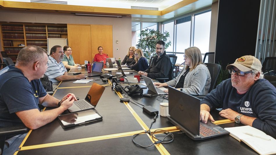A group of people working around a table.