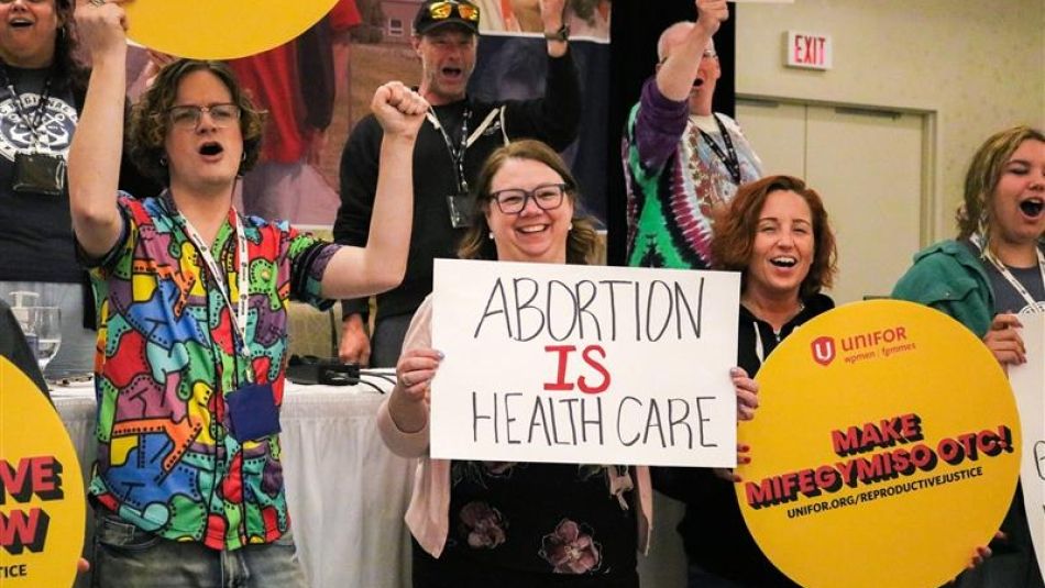 A group of people holding signs chanting