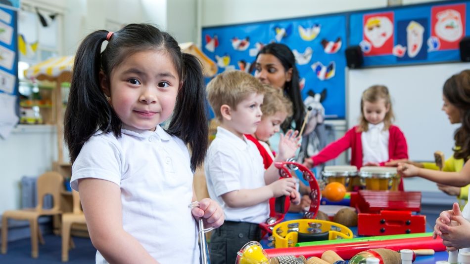 Children playing in a daycare facility under the supervision of an ECE.