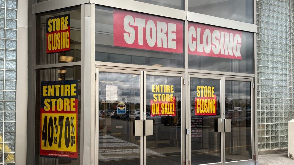 Store font door with a store closing sign on the front door.