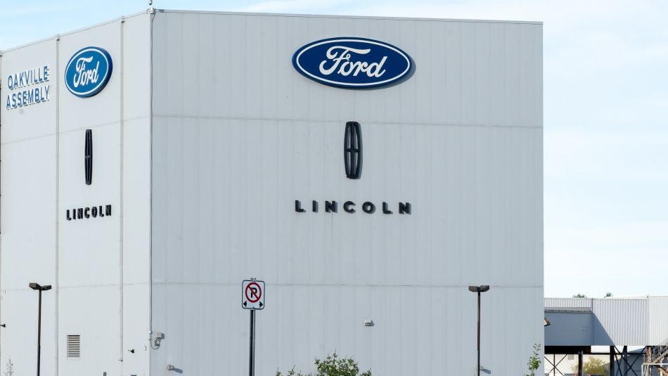 Exterior of a large building with a Ford sign on it 
