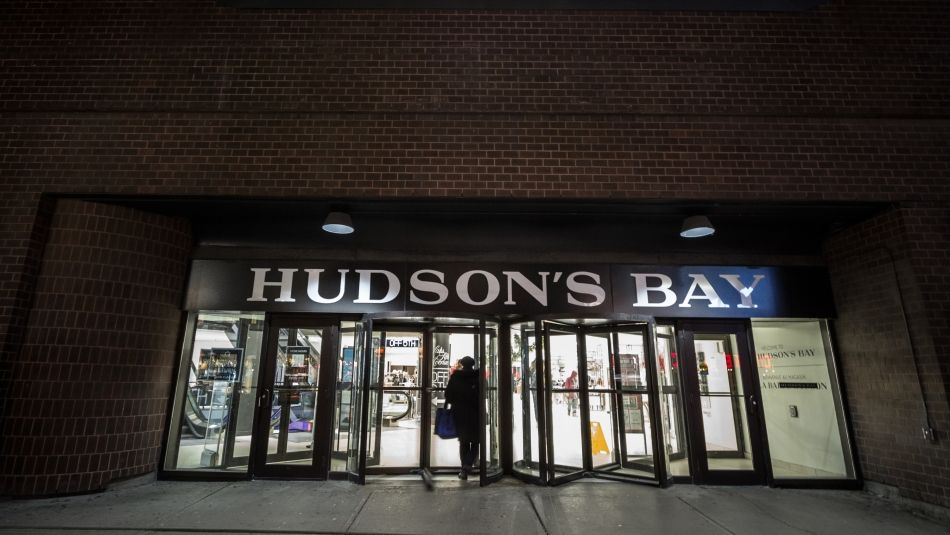 People walking into the Hudson Bay at night.