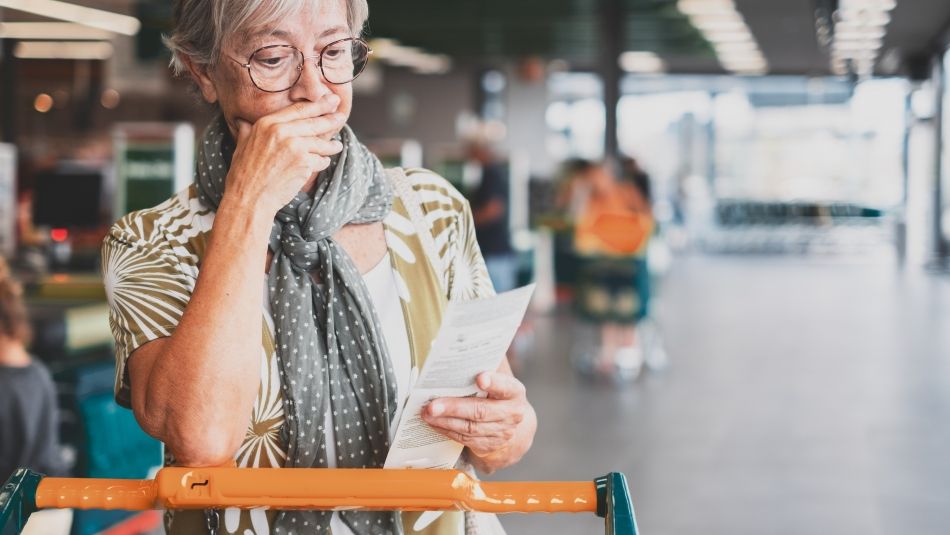 A women is shock checking her grocery bill