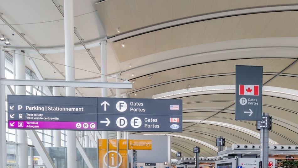 A Canadian airport with way finding signage.