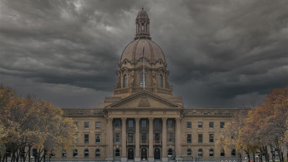 Alberta legislature building with dark clouds overhead.