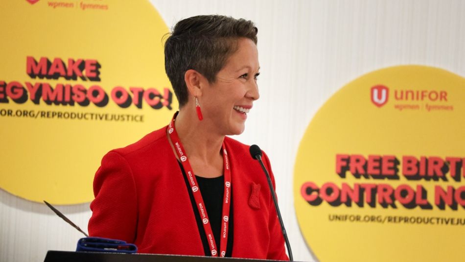  NDP MLA Melanie Mark standing at the podium during Unifor's BC Women's Conference.