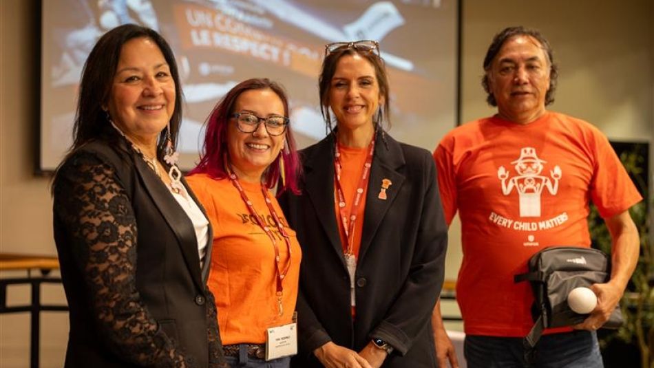 Four people wearing orange shirts