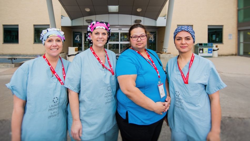 four nurses smiling 
