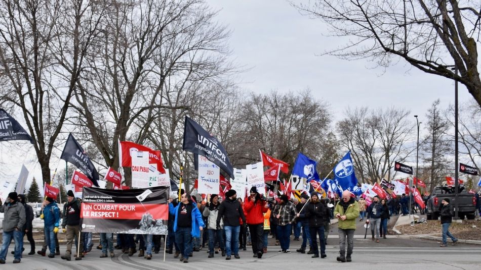 Ash Grove workers carry banners and march.