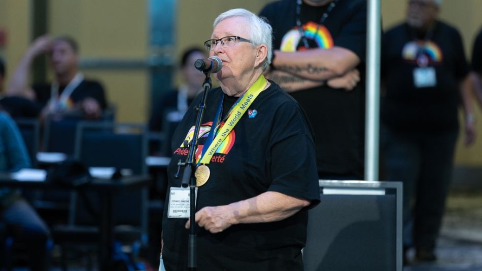 Stephanie Johnstone, a senior with short grey hair, speaks at the microphone.