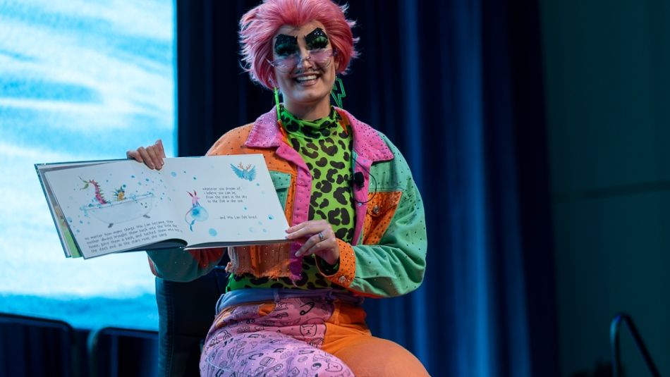 Drag king Cyril Cinder holds a book.