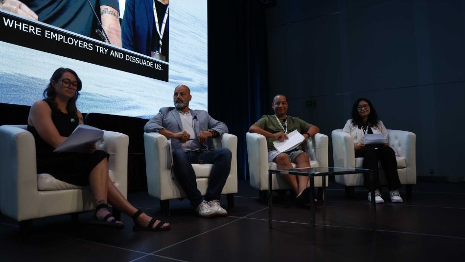 A panel sitting in chairs.