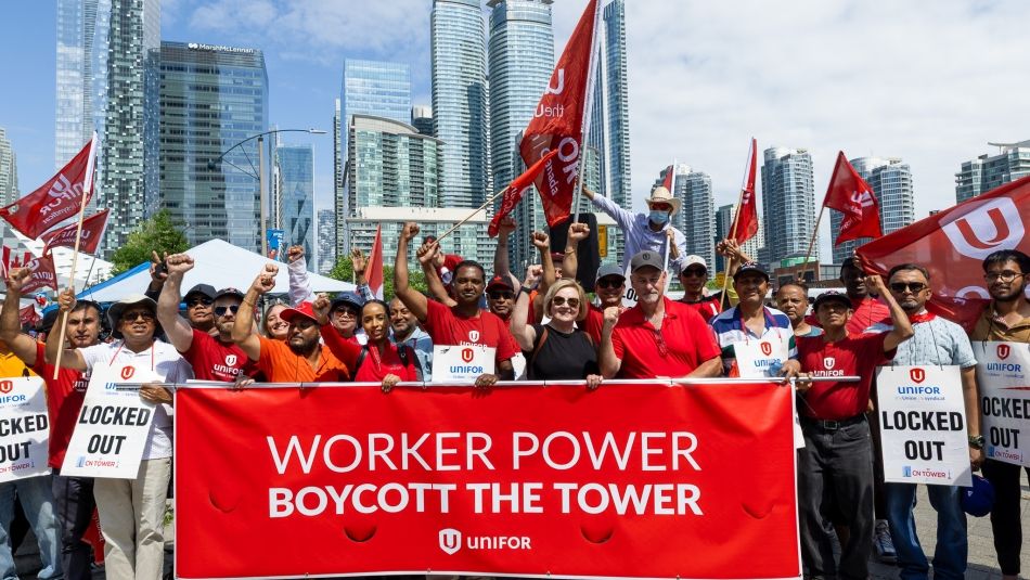 group of people holding a banner 