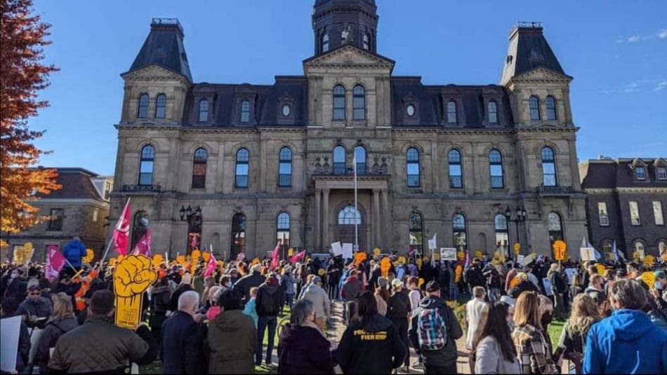 Des membres du SCFP NB en grève se rassemblent devant l'édifice de l'Assemblée législative du Nouveau-Brunswick.