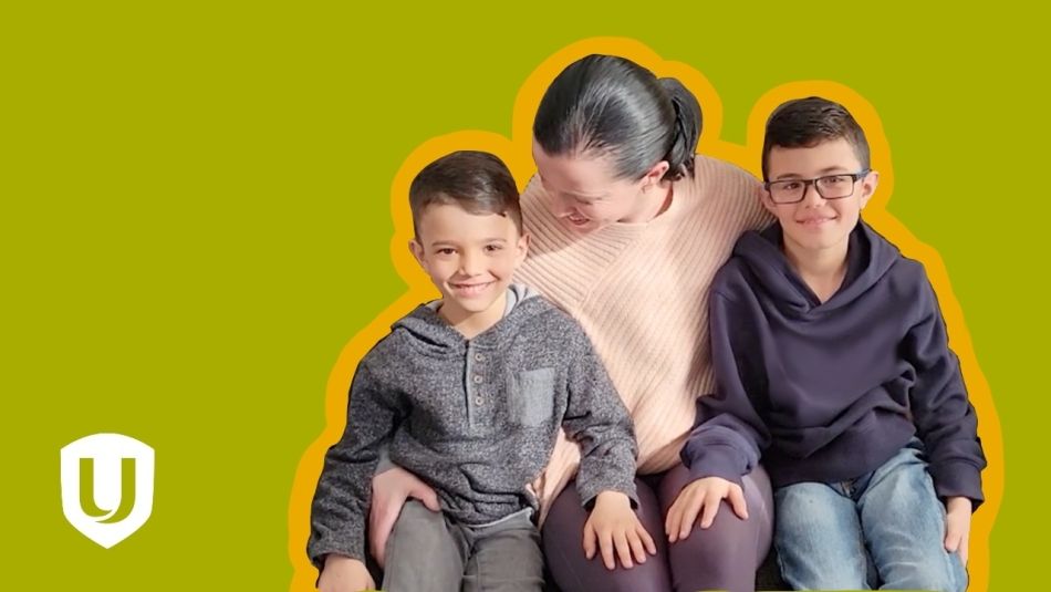 A woman sitting with two young children.